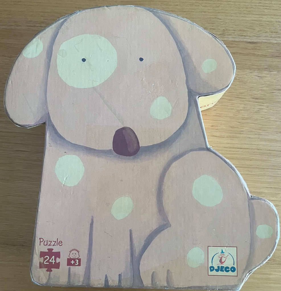 A whimsical illustration of a light lavender puppy with soft cream-colored spots.