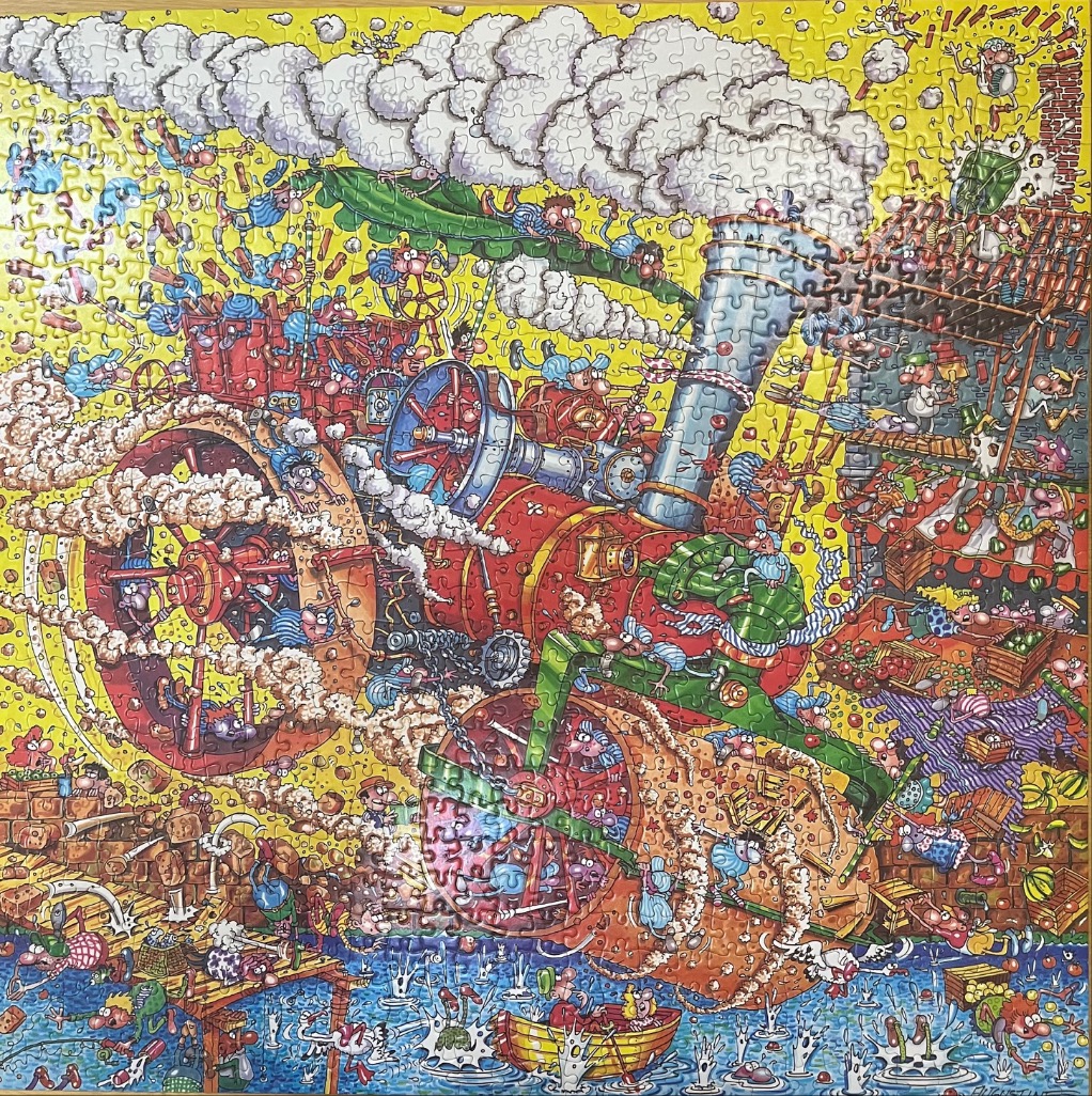 Cartoon illustration of a chaotic, busy scene featuring a massive red steam engine and numerous small characters.
