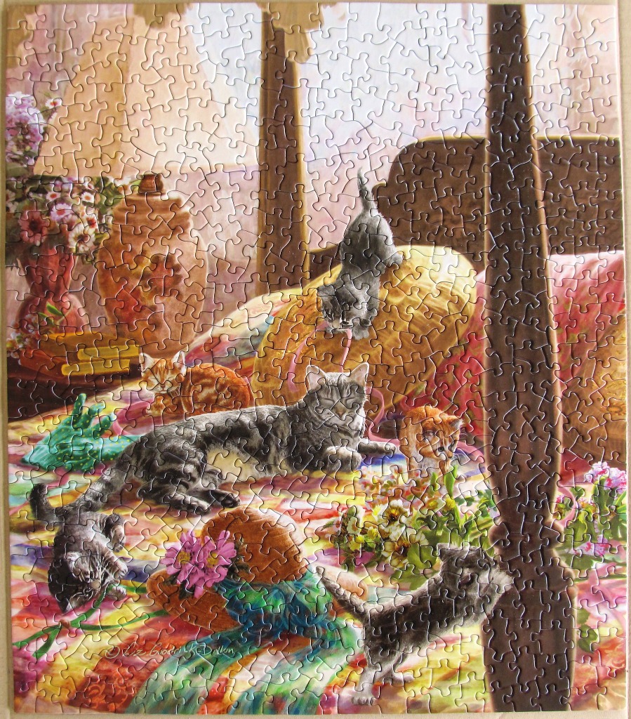 An illustration of several kittens playing on a patterned quilt near a wooden bed frame.