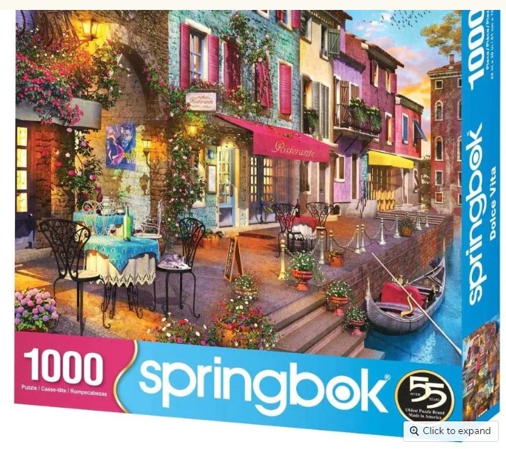 A scenic Italian waterfront canal restaurant featuring colorful buildings, outdoor tables, and a gondola.