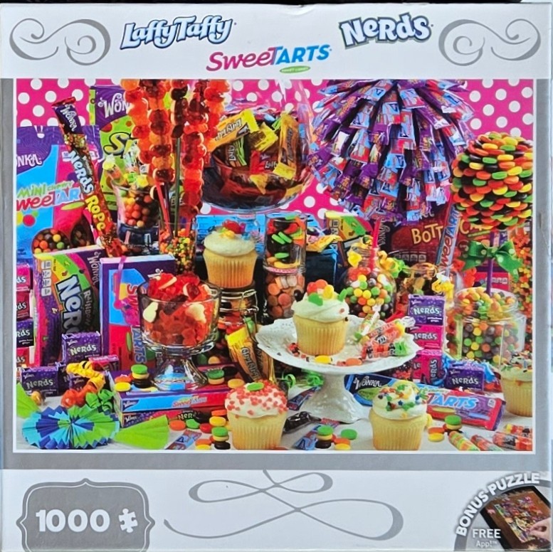 A vibrant assortment of various colorful candies and cupcakes arranged against a pink and white polka-dot background.