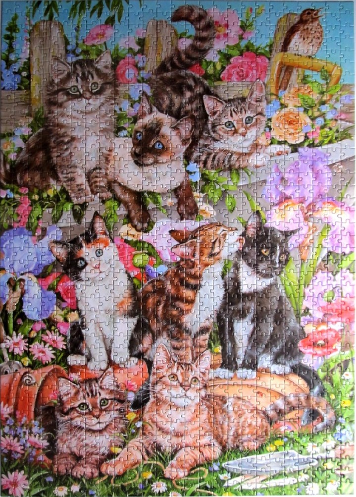 A whimsical illustration of eight kittens playing in a vibrant, sunlit flower garden.