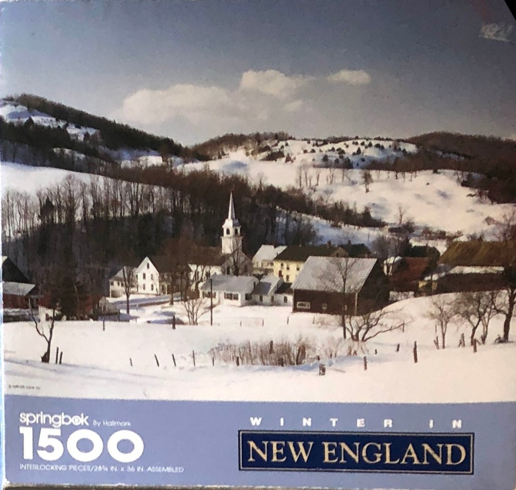 A nostalgic winter landscape featuring a small New England village nestled in snow-covered hills under a clear blue sky.