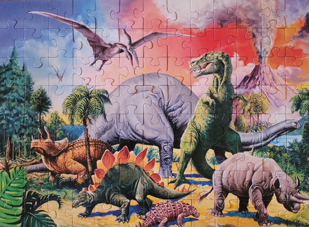 Prehistoric dinosaur landscape with a volcano, a pterosaur, and several species of dinosaurs including a T-Rex.