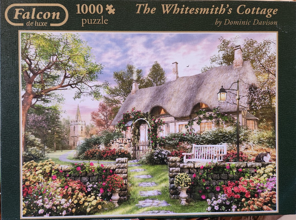 A thatched cottage with a rose-covered arbor and vibrant flower gardens in a peaceful countryside setting.