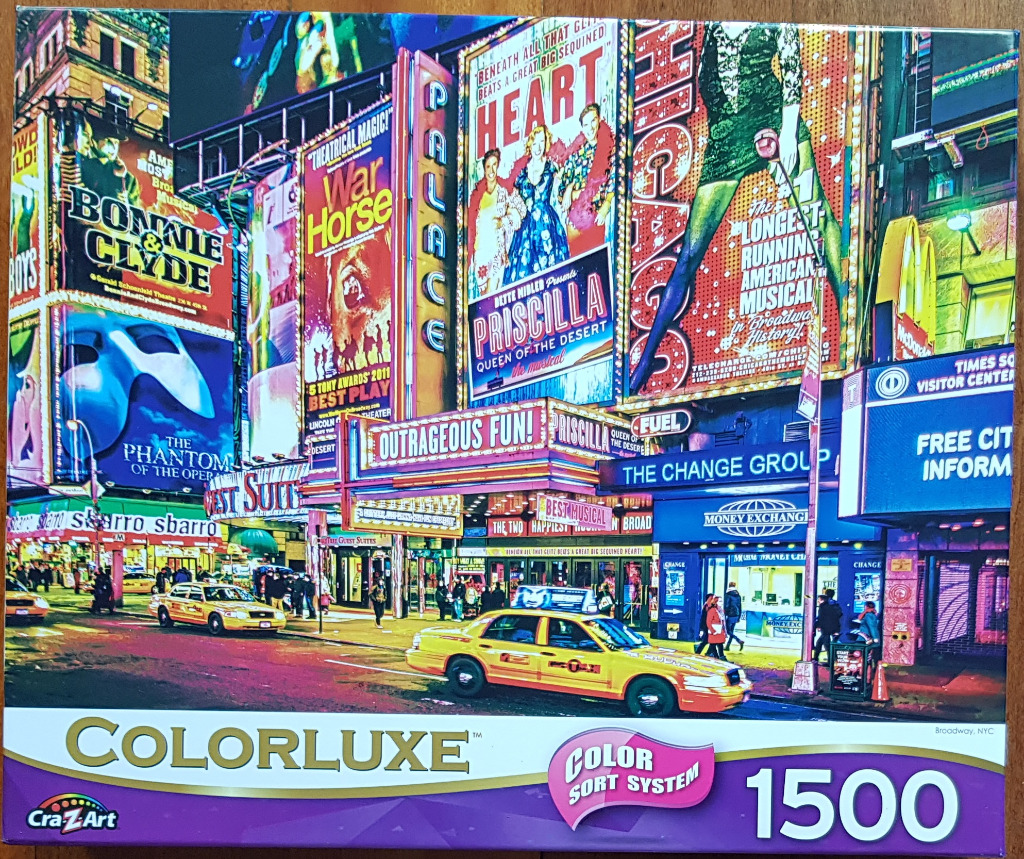 A night scene in New York City's Times Square featuring vibrant theater billboards and yellow taxis.