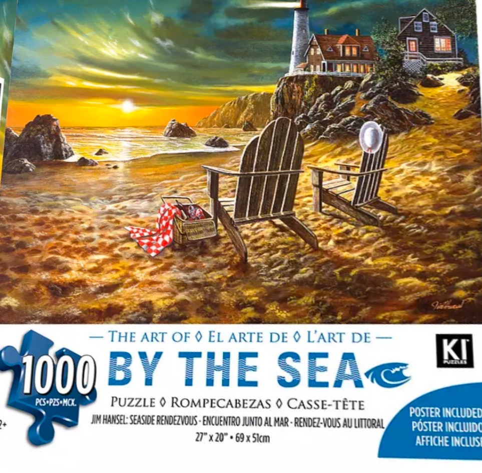 Two wooden Adirondack chairs facing a sunset beach with a lighthouse and cottage on a cliff