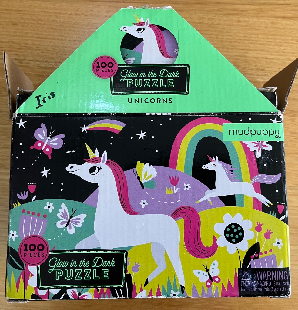 Whimsical illustration of white unicorns with pink manes playing in a stylized, colorful magical landscape.