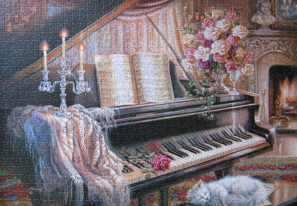 A black grand piano adorned with a crystal candelabra, floral bouquet, and a sleeping white cat in a cozy room.