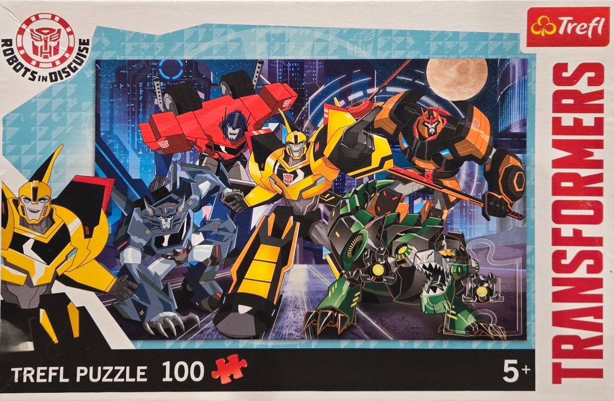 Five Transformers robots in a dynamic, stylized action pose against a futuristic night city backdrop.