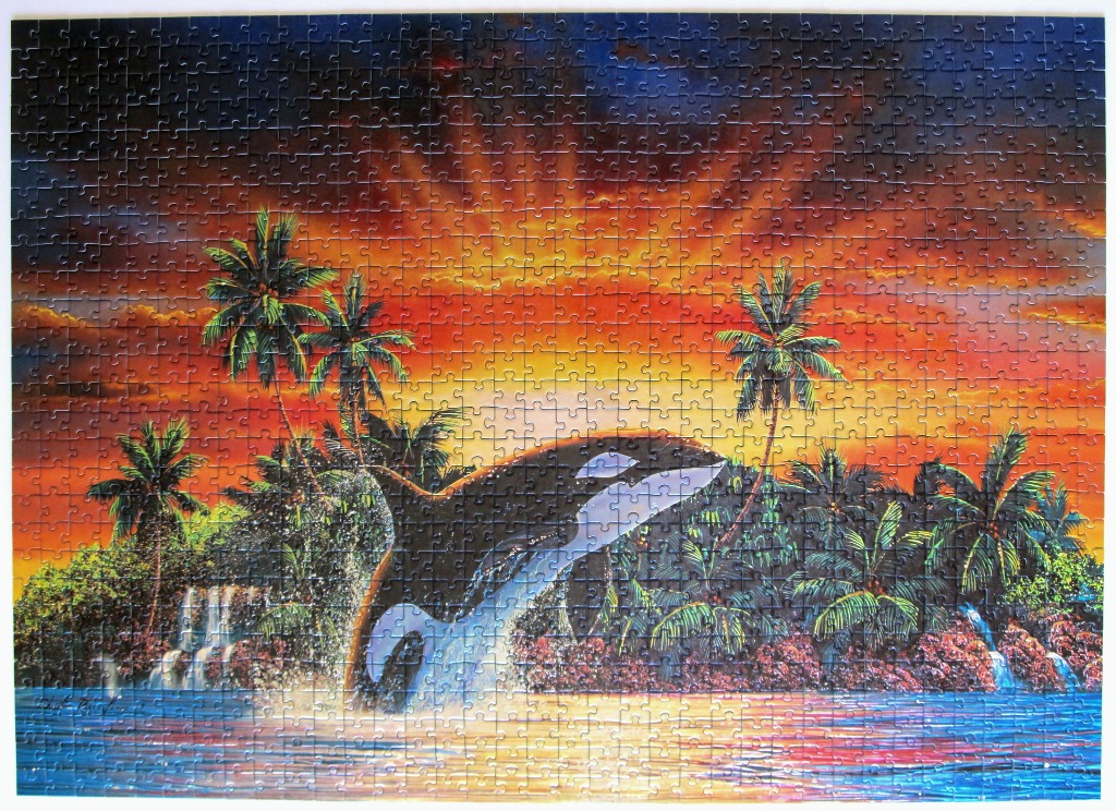 An orca leaps out of tropical water at sunset against a backdrop of palm trees and waterfalls.