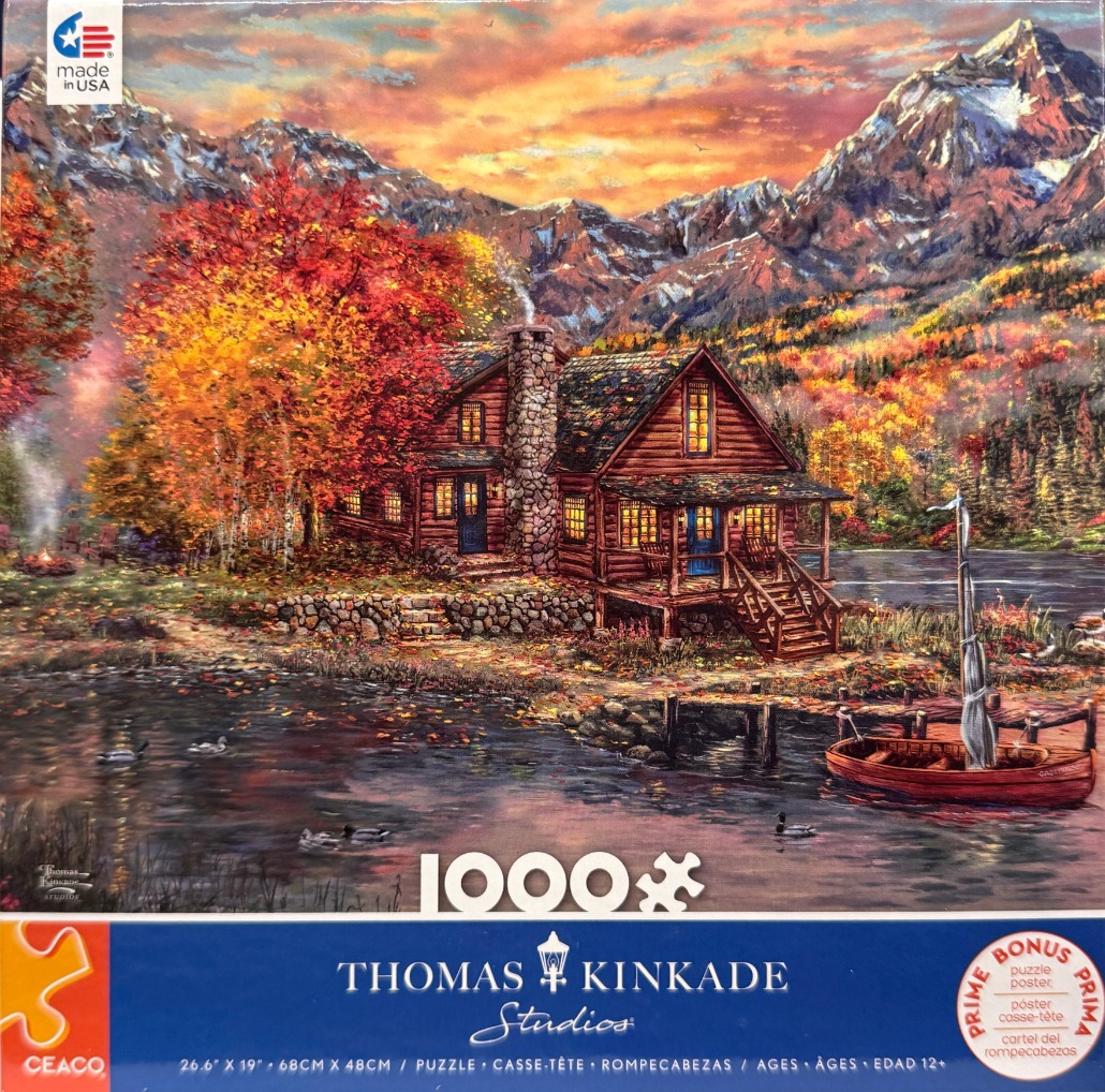 A cozy log cabin at sunset by a lakeside with mountains in the background, featuring vibrant autumn foliage.