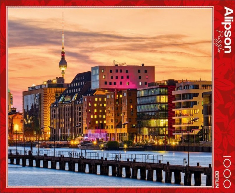 A sunset view of the Berlin skyline across a river with the TV Tower prominently on the left.
