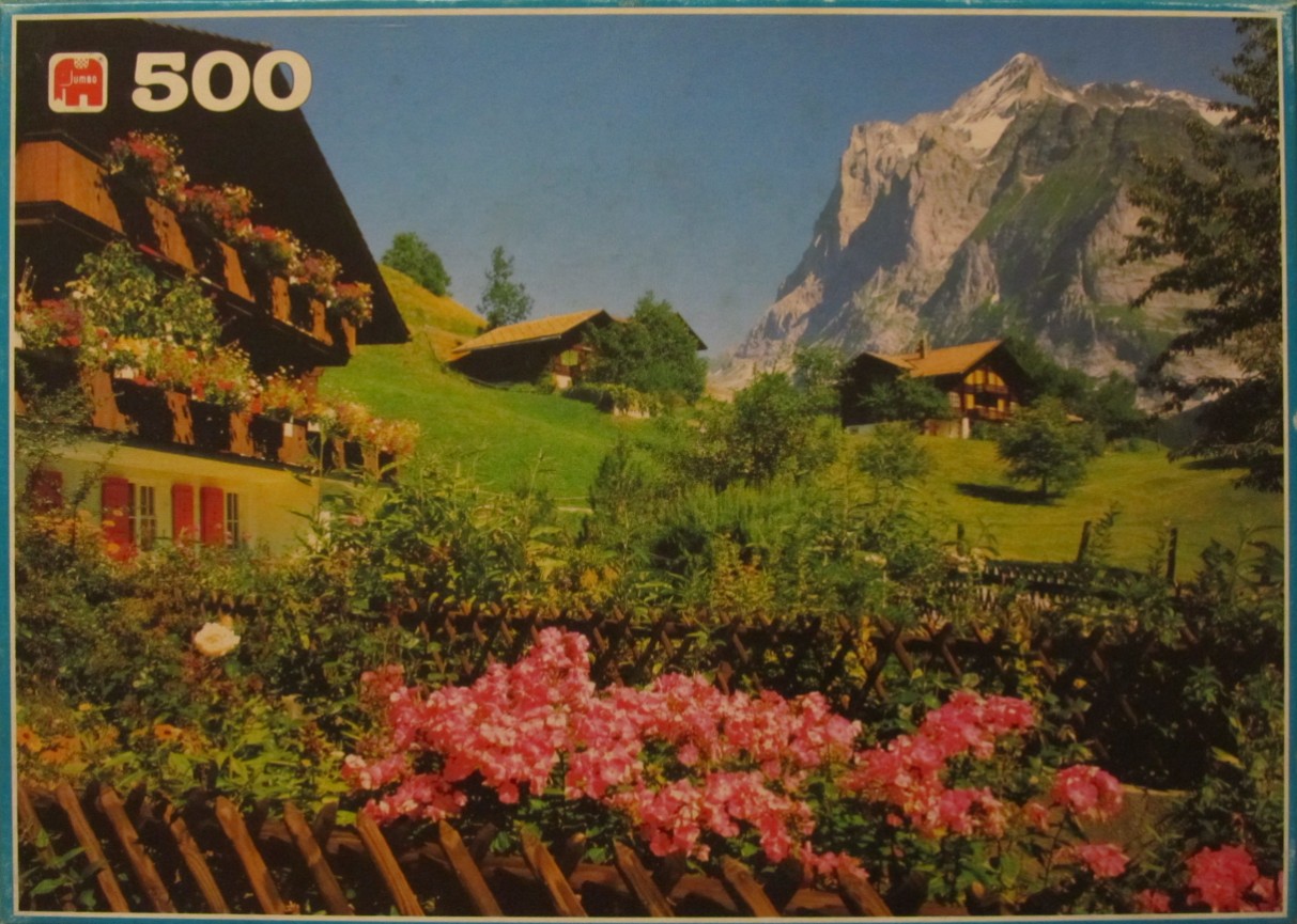Alpine landscape with traditional wooden chalets, flower-filled gardens, and a towering mountain in the background.