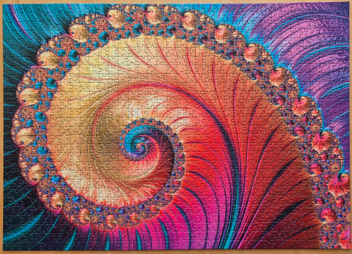 A digital fractal art piece featuring a vibrant, swirling spiral with intricate, repeating patterns in shades of red, gold, a