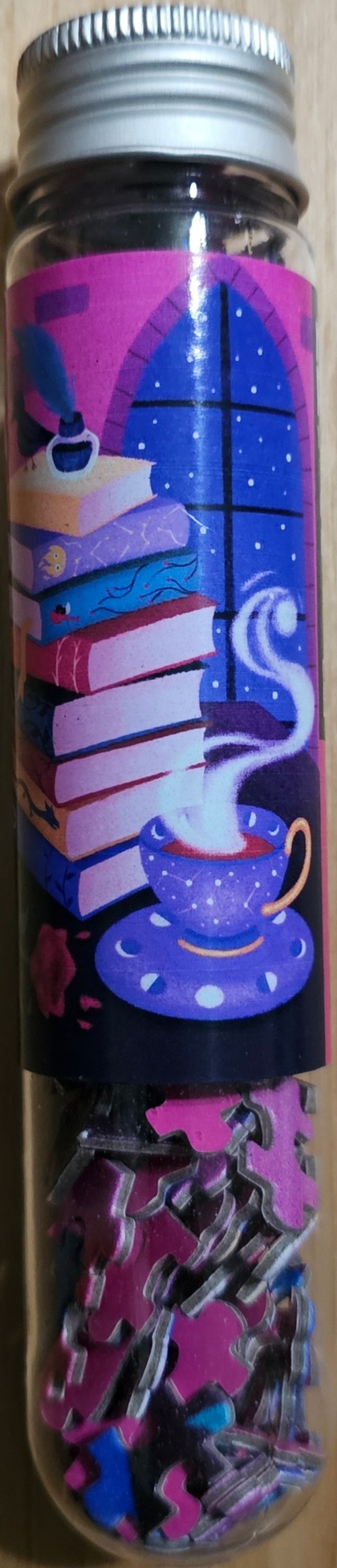 An illustration of a stack of books and a steaming cup of tea in front of a dark window.