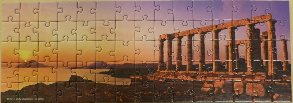 Ancient Greek temple ruins on a cliffside at sunset