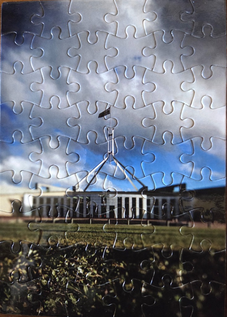 Parliament House in Canberra under a blue and cloudy sky