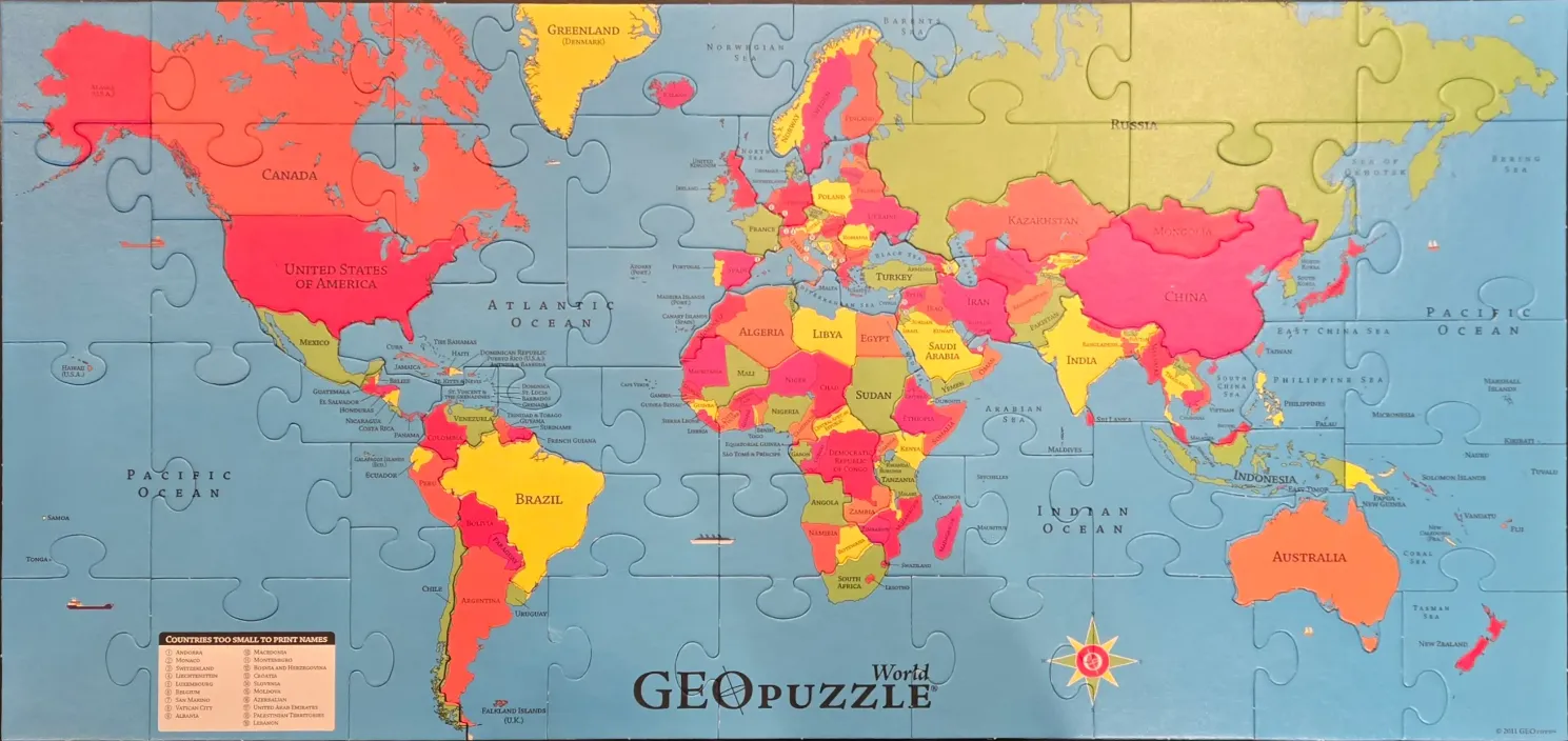 A colorful educational world map illustration showing continents and countries in shades of pink, yellow, red, and green.