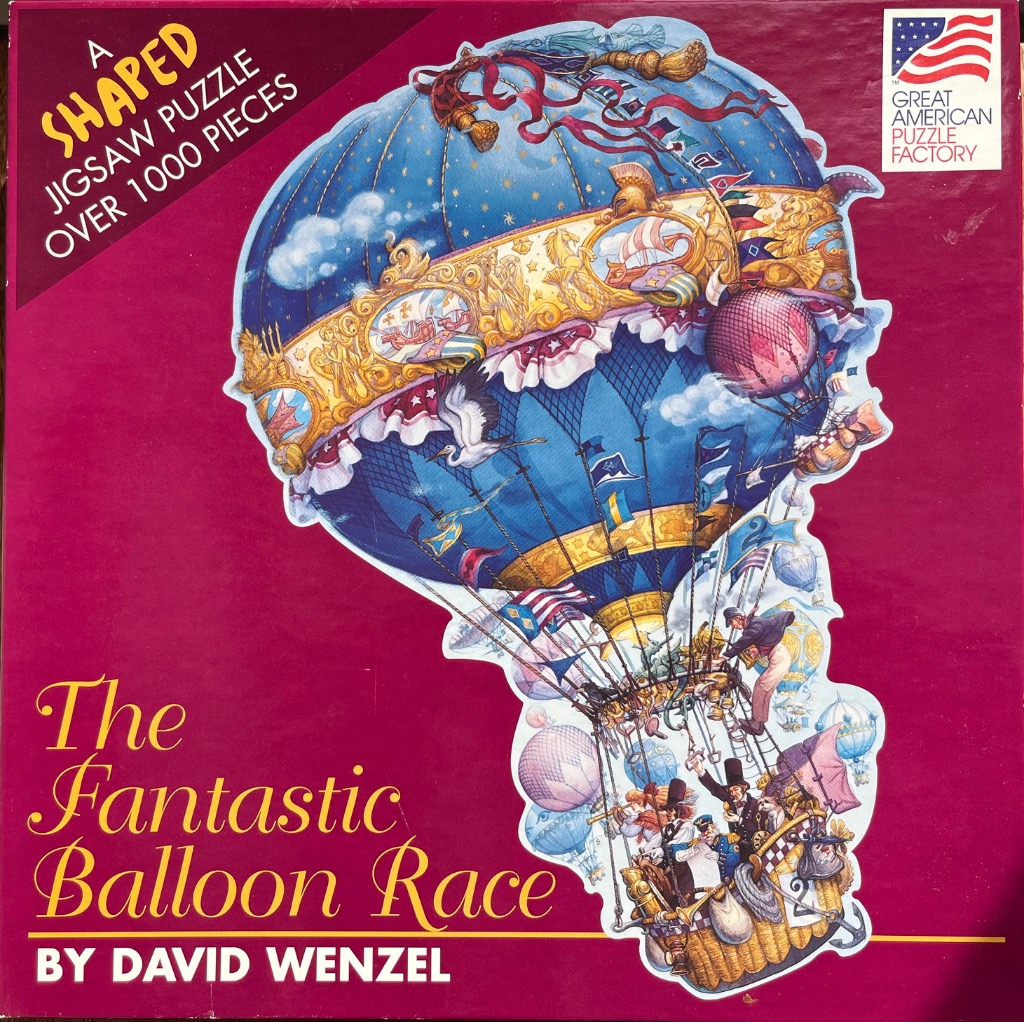 An ornate, blue hot air balloon with classical artwork and Victorian figures in the basket.