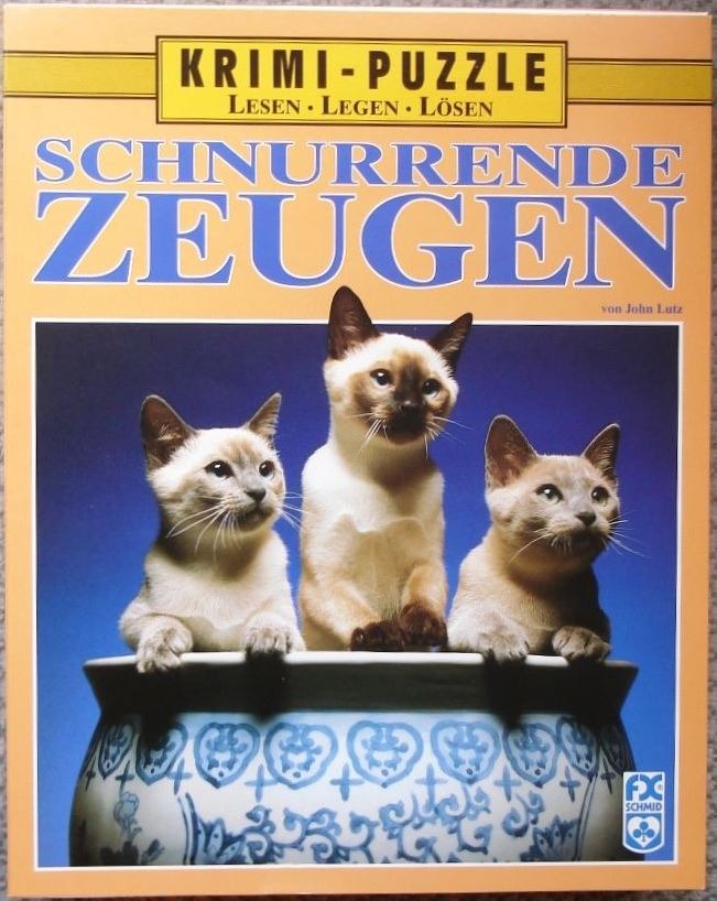 Three Siamese kittens perched on the rim of a blue and white patterned ceramic pot against a blue background.