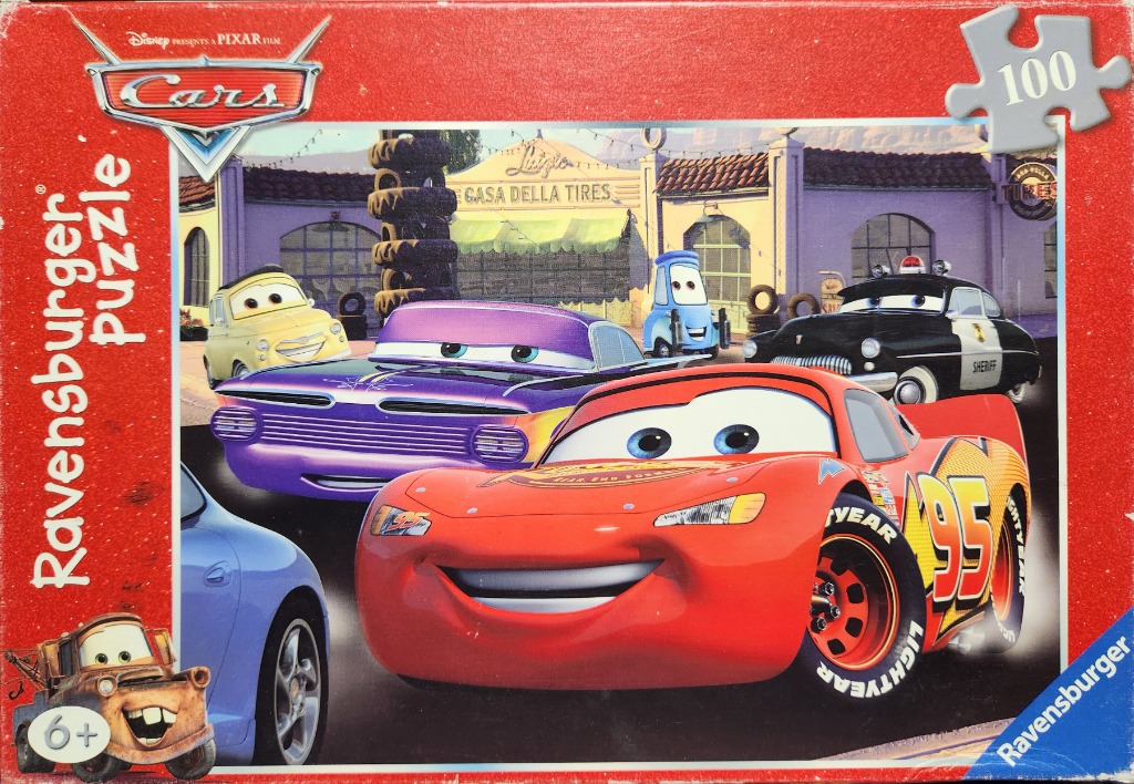 A group of anthropomorphic character cars parked in front of Casa Della Tires.