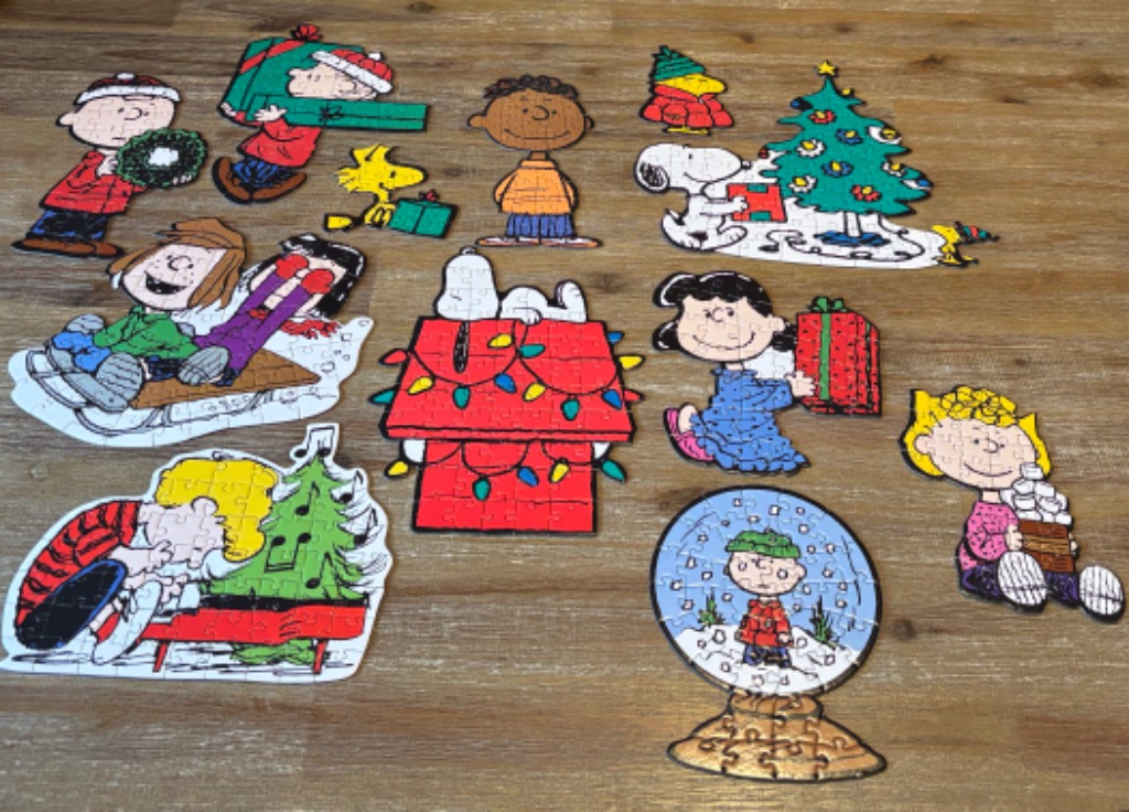 An assortment of individual Peanuts holiday-themed cutouts featuring Charlie Brown, Snoopy, and their friends.