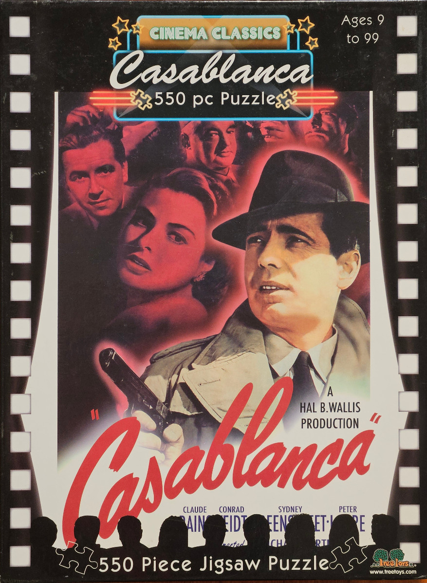 Vintage movie poster artwork for Casablanca featuring Humphrey Bogart and Ingrid Bergman in a dramatic red and black tone.