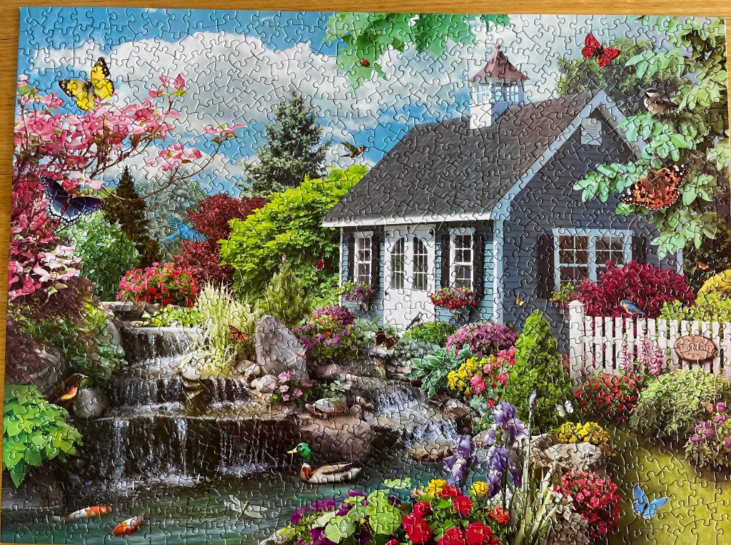 A peaceful garden landscape with a blue shed, cascading waterfall, and various butterflies and birds.