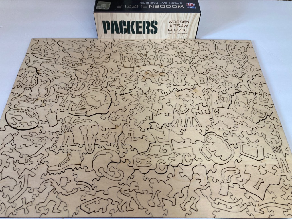 Wooden surface featuring engraved outlines of football-themed icons and figures.