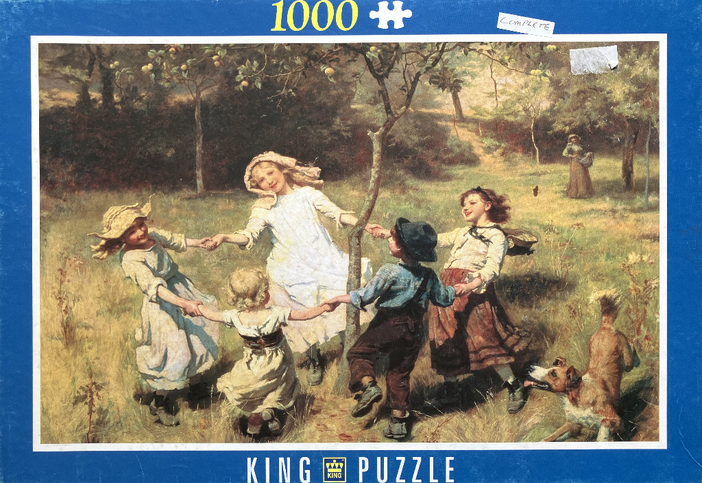 A group of four children holding hands and dancing in a circle around a tree in a sunny, pastoral meadow.