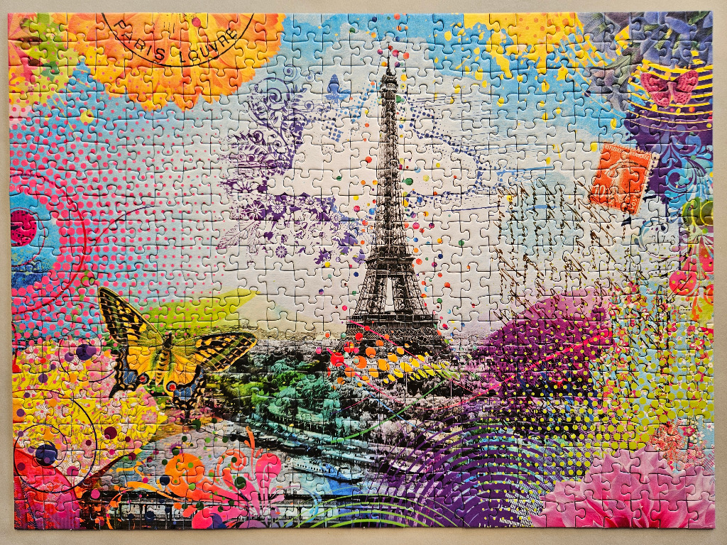 A colorful, artistic montage of the Eiffel Tower in Paris overlaid with butterflies, floral patterns, and postage stamps.