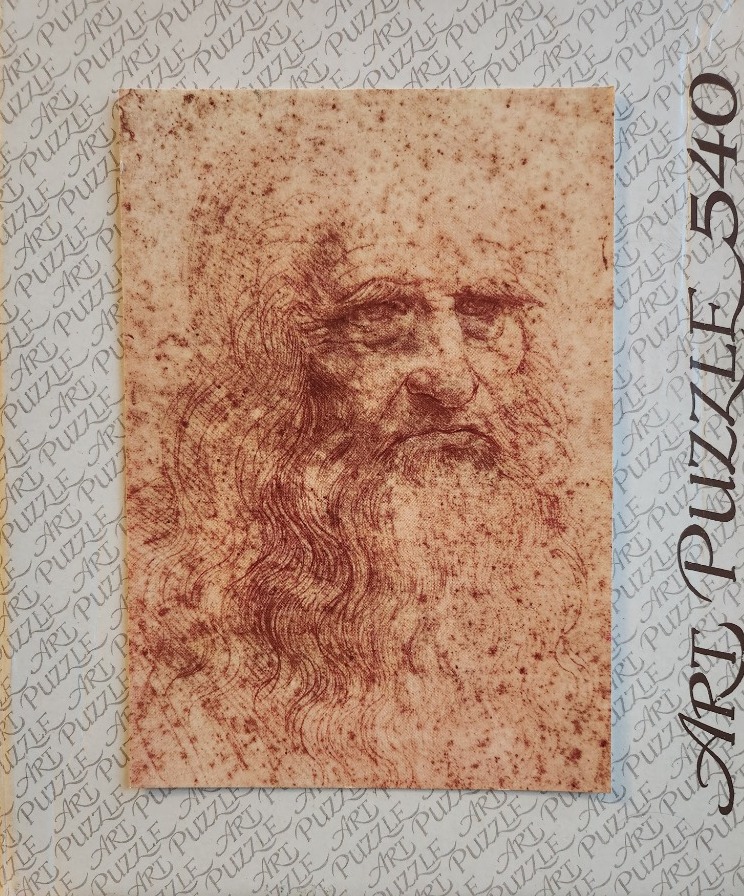 A red chalk portrait sketch of Leonardo da Vinci’s self-portrait on textured paper.