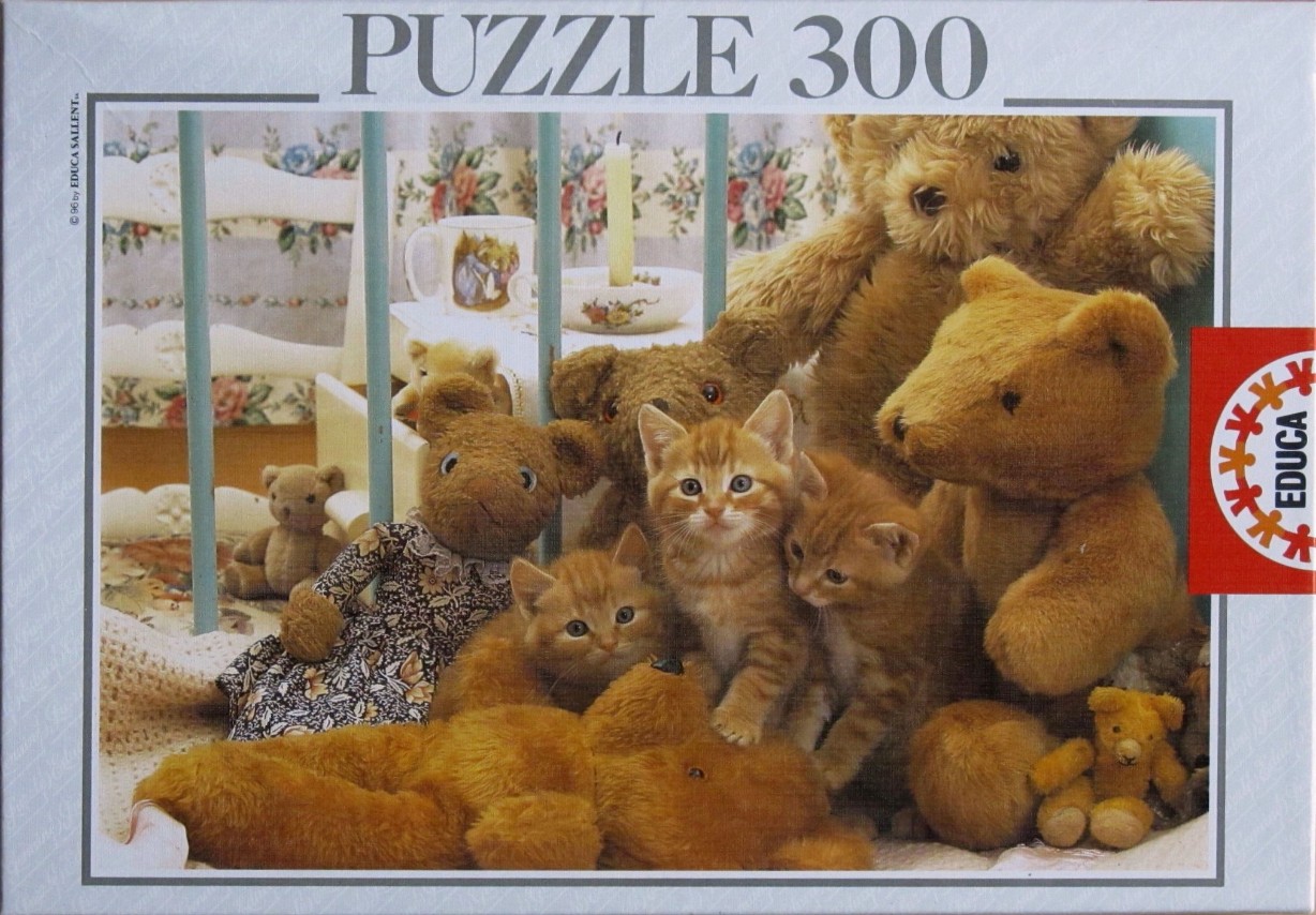 Three ginger kittens sitting amongst several plush teddy bears in a bedroom setting.