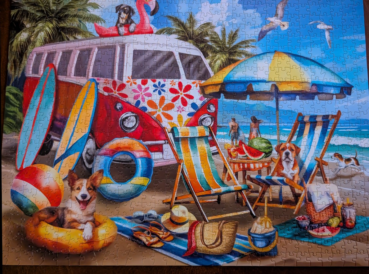 A sunny beach scene featuring a vintage flower-power van, colorful umbrellas, beach chairs, and several dogs.