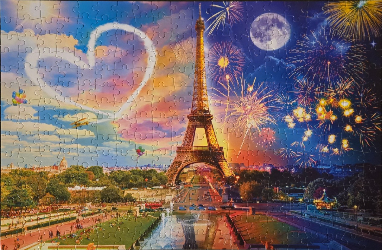 Digital art of the Eiffel Tower at night featuring a day-to-night gradient sky with fireworks and a heart-shaped cloud.
