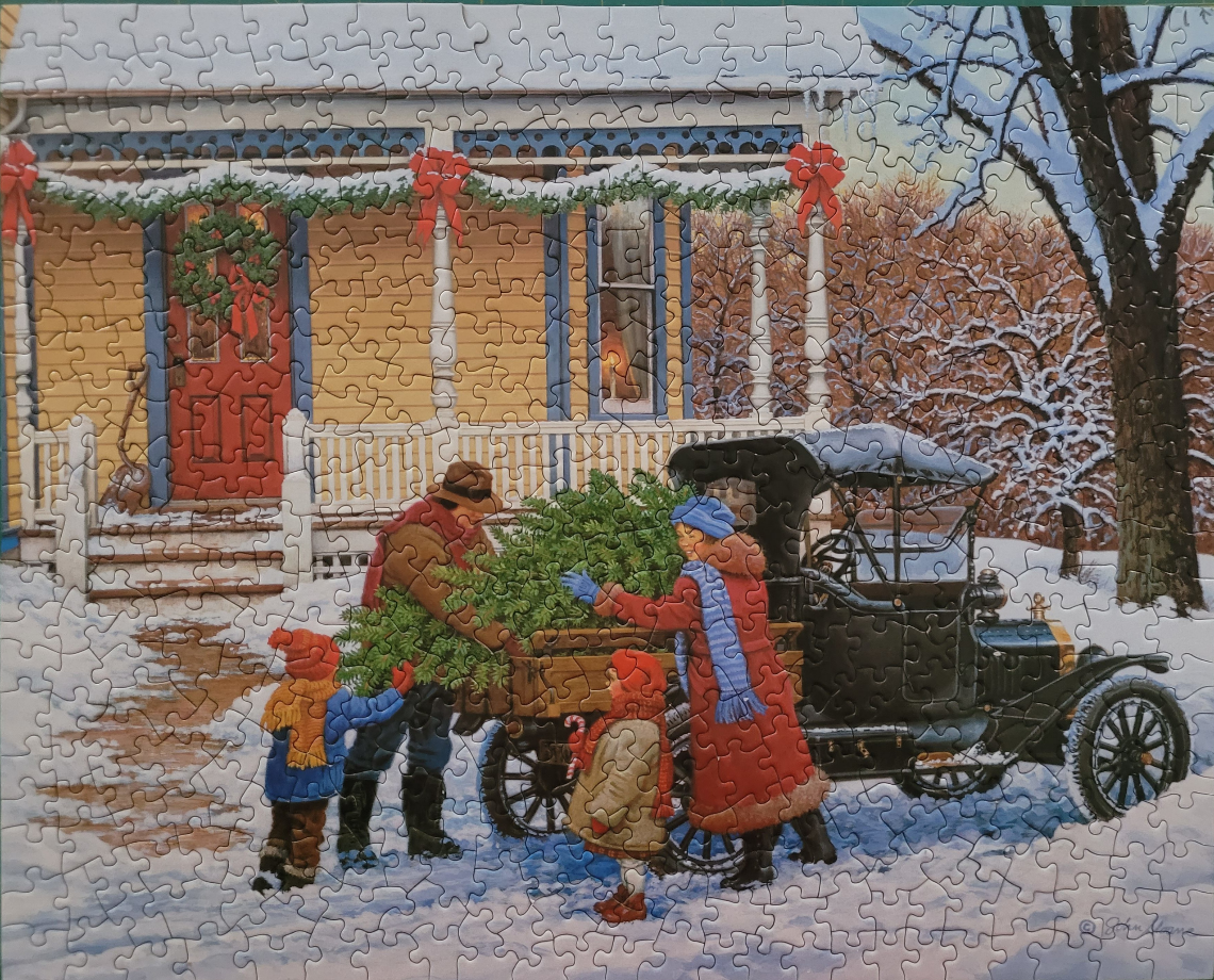 A family unloading a Christmas tree from a vintage car in front of a yellow house in winter.
