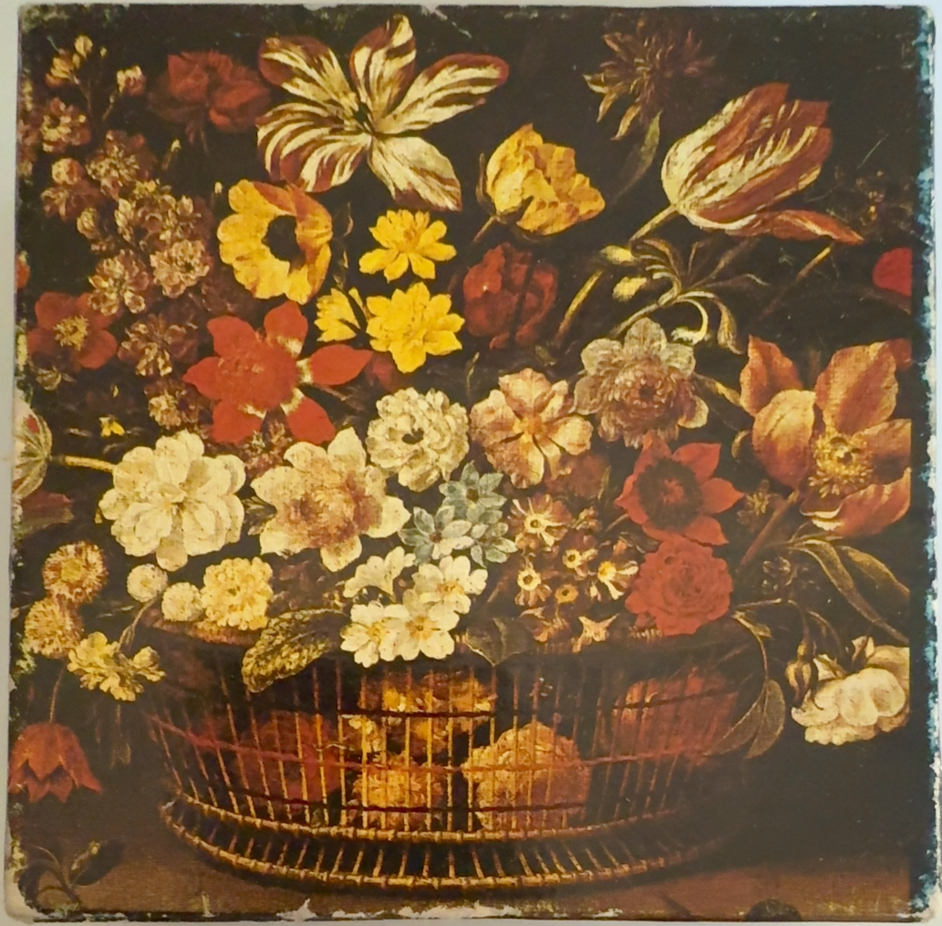 A lush 17th-century style floral still life in a wire basket against a dark background.