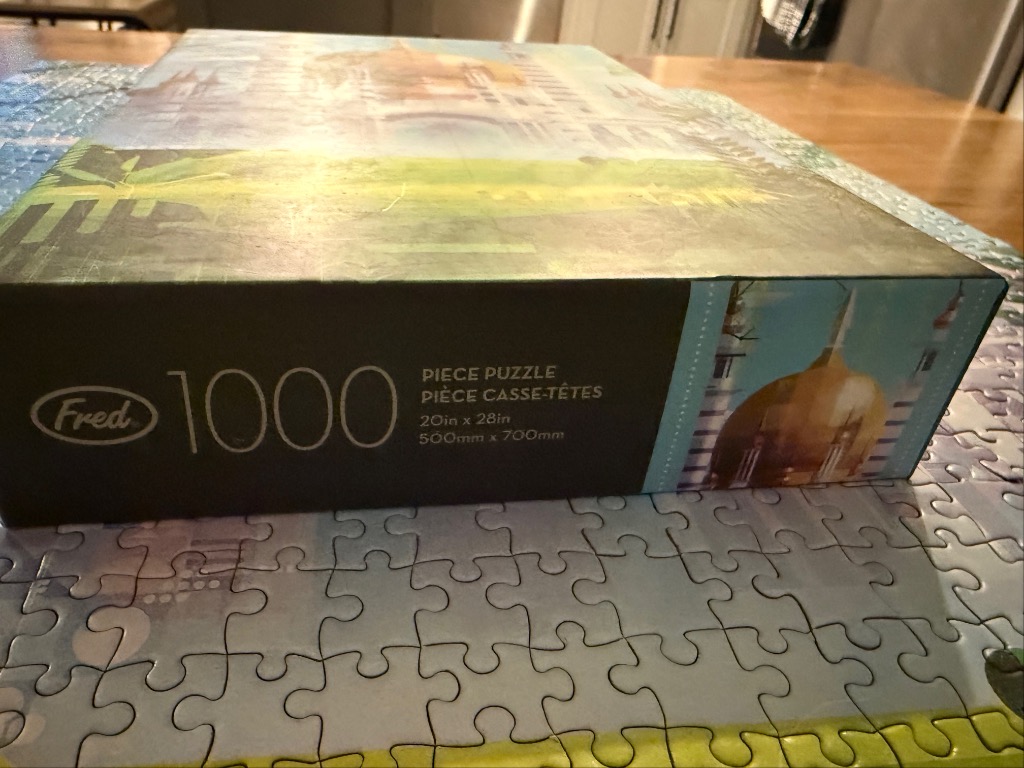 Cityscape with gold domes, green fields, and blue sky on a 1000-piece puzzle.