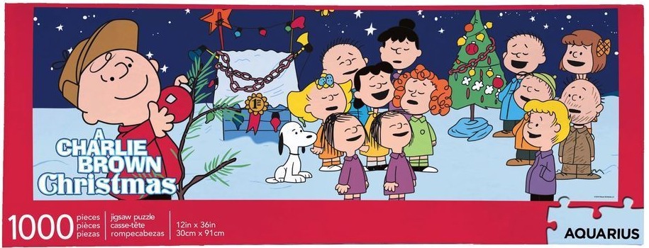 Charlie Brown and the Peanuts gang singing around a Christmas tree under a night sky.