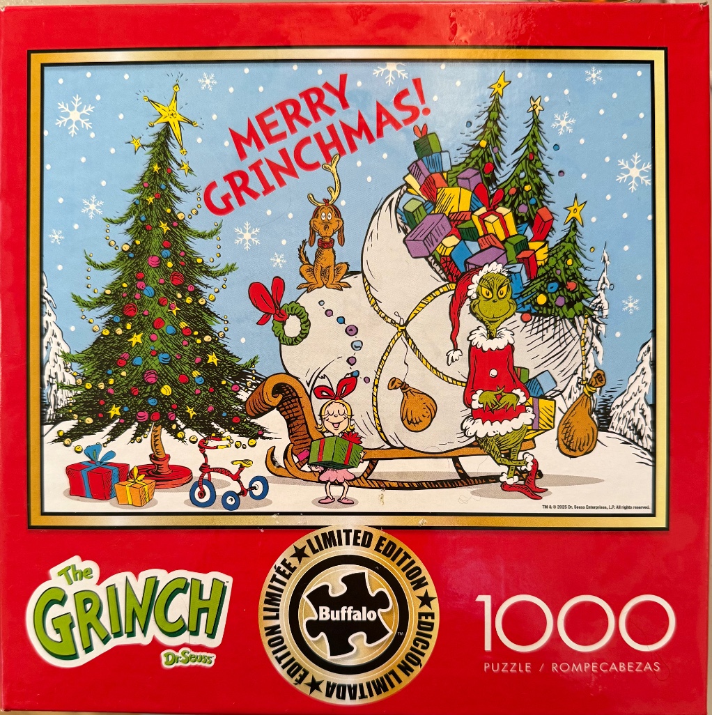 The Grinch and Cindy Lou Who standing next to a sleigh full of presents in a snowy Christmas scene.