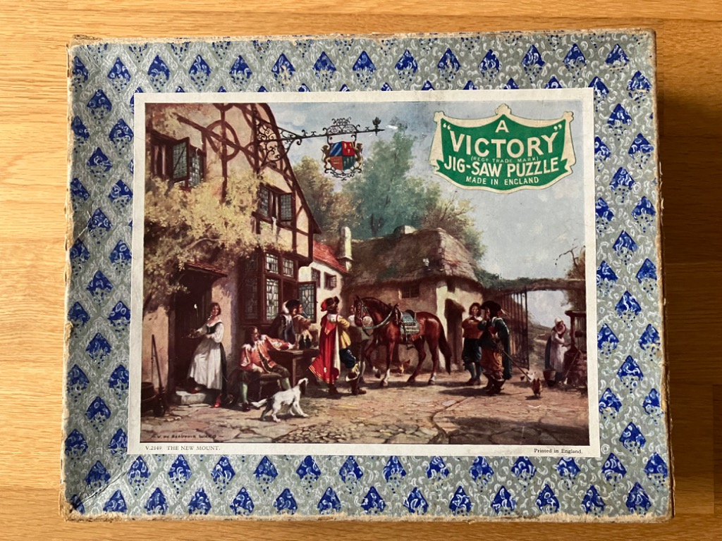 A vintage painting of an 18th-century English inn scene with travelers, horses, and a tavern sign.