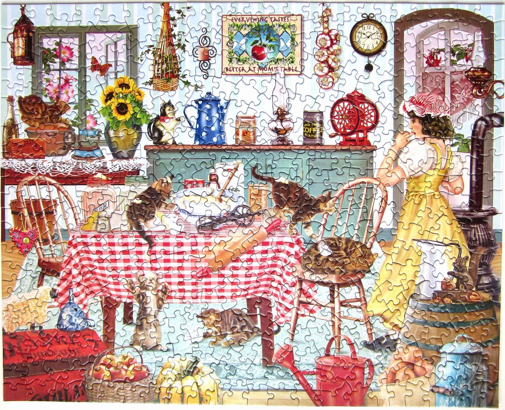 A cozy country kitchen scene featuring a woman in a yellow dress baking with several cats roaming the table and floor.
