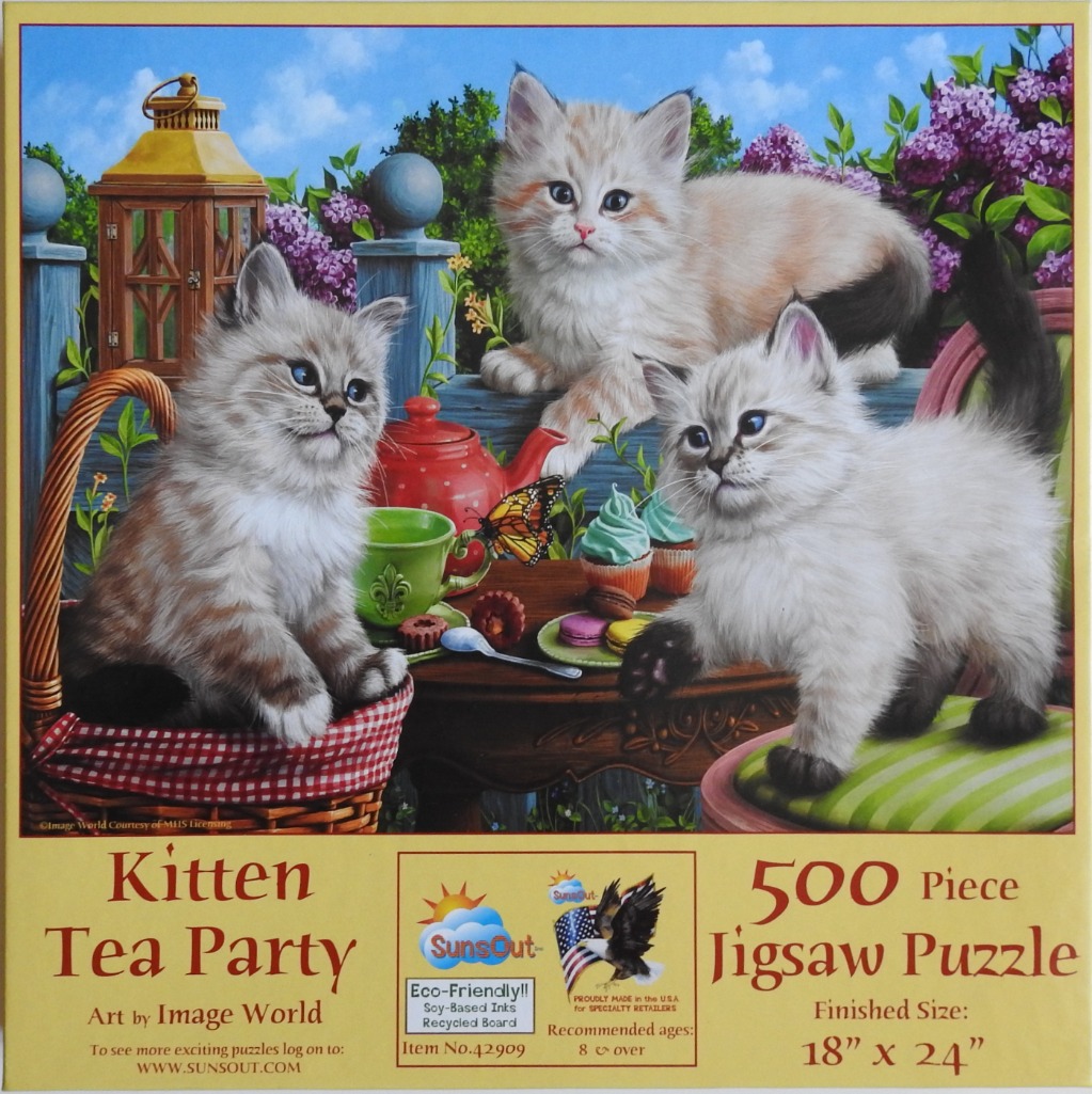 Three fluffy kittens having a tea party in a garden setting.