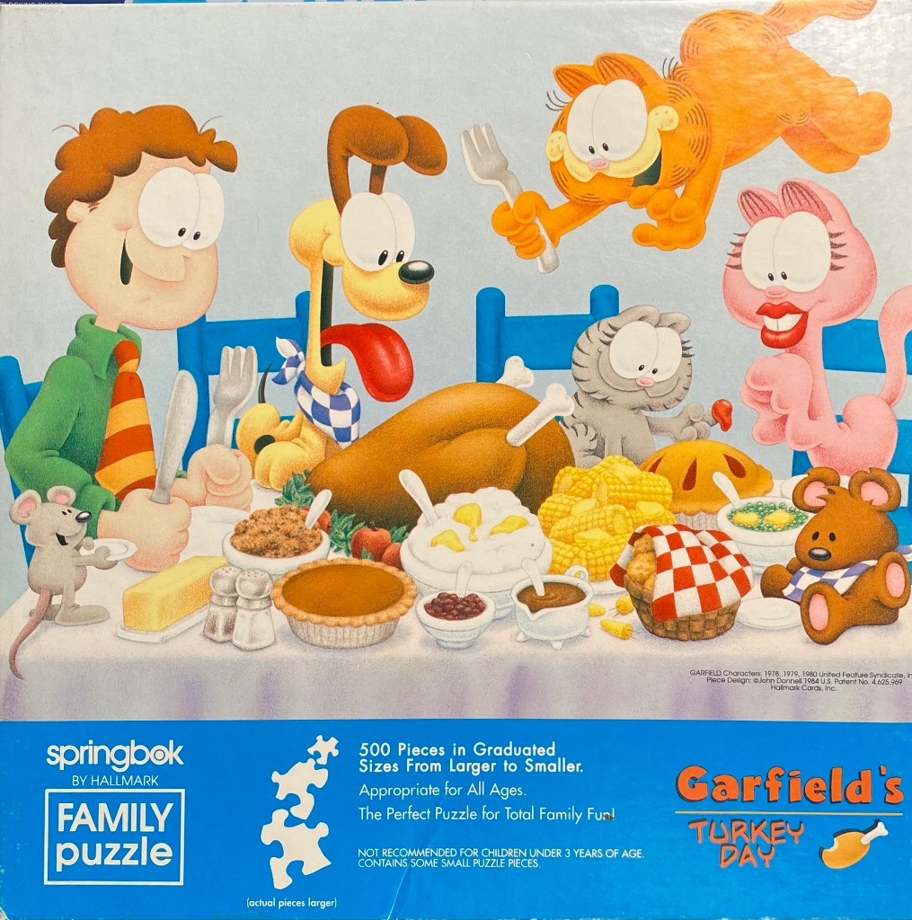 Cartoon illustration of Garfield, Odie, and friends enjoying a Thanksgiving feast around a dining table.