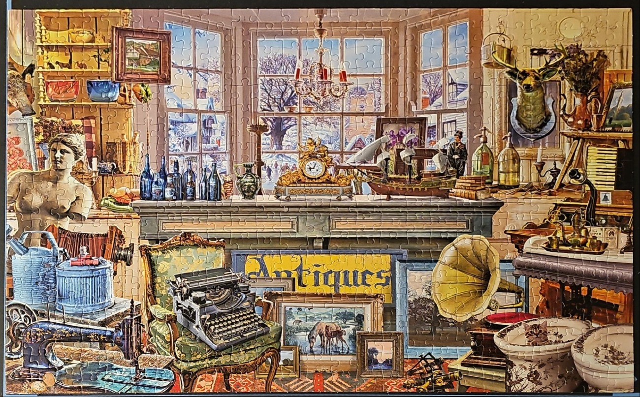 A cluttered antique shop interior overlooking a snowy landscape.
