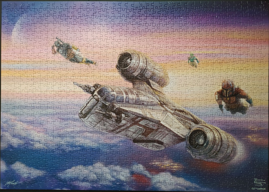 The Mandalorian, Boba Fett, and Bo-Katan flying alongside the Razor Crest ship in a sunset sky.