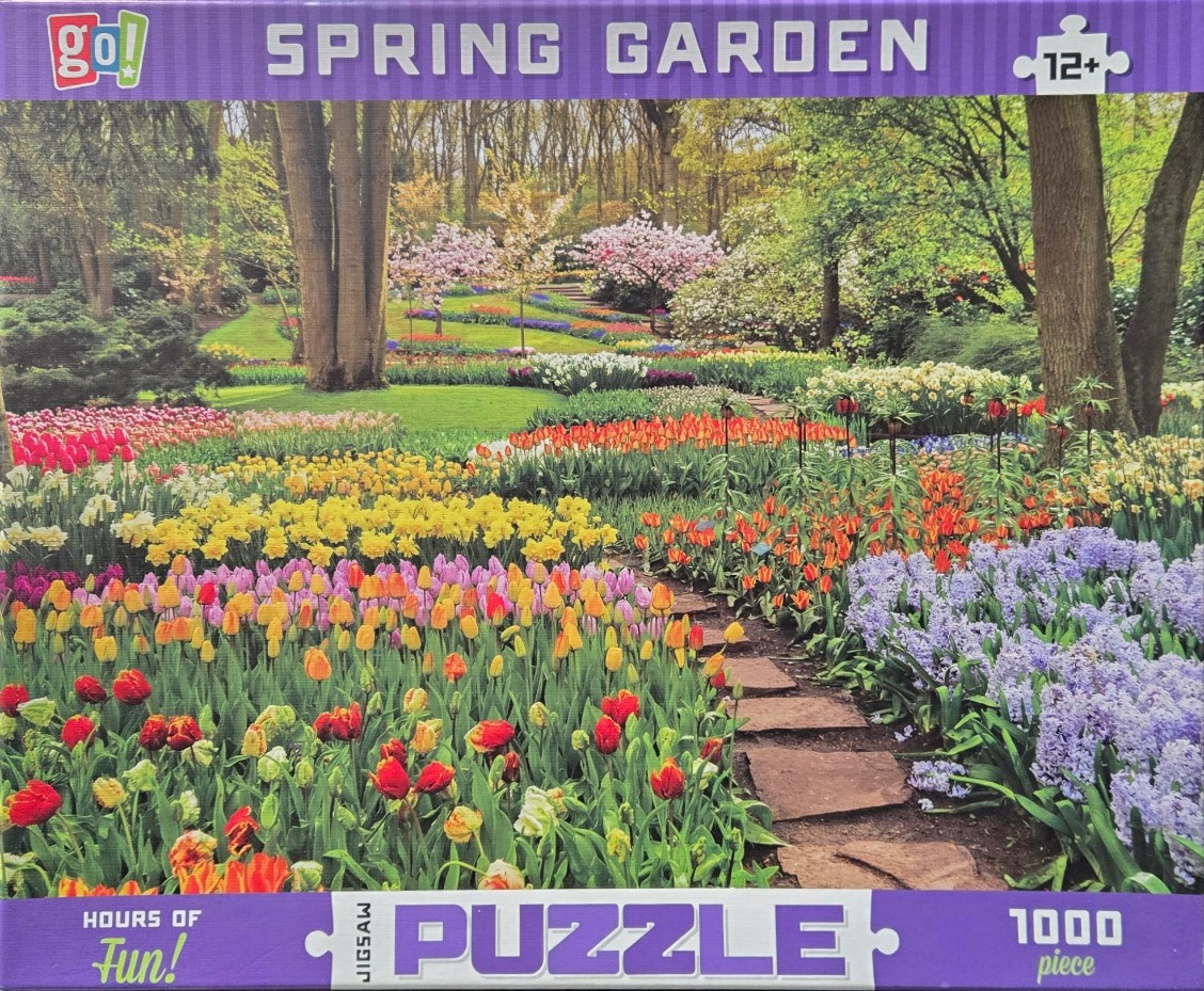 A lush spring garden filled with colorful tulips, hyacinths, and flowering trees along a stone path.