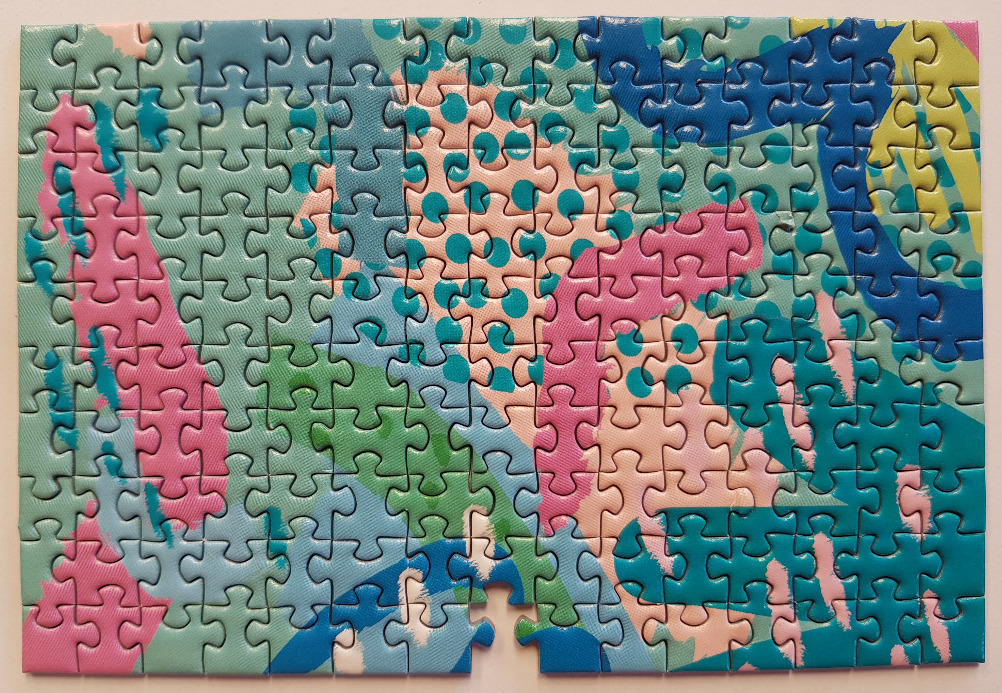 Abstract design with layered polka dots and brushstroke shapes in pink, green, and blue.