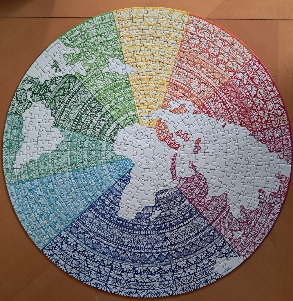 A circular illustration of a world map featuring colorful, intricate mandala-style patterns on the landmasses.